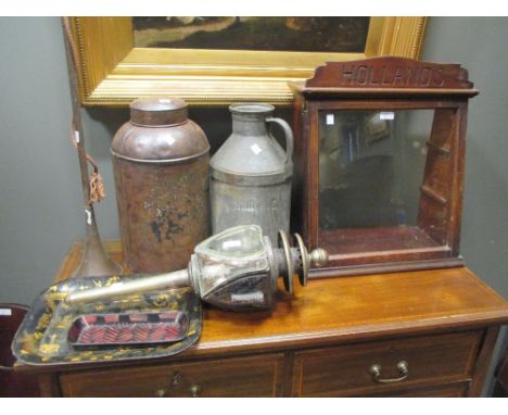 An Edwardian 'Hollands' shop display cabinet, coaching lamp and metal canisters  