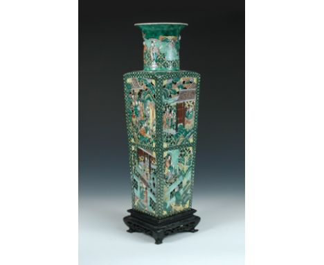 A 19th century famille verte reticulated vase, seal mark of Kangxi, 51cm (20 in) high with a wood stand (2)  This has a hair 