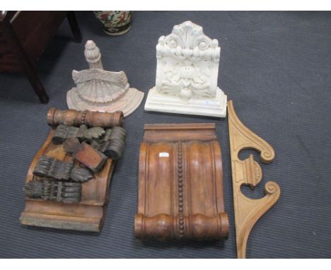 A pair of carved wooden corbels, white painted plaster corbel and a wooden wall bracket  