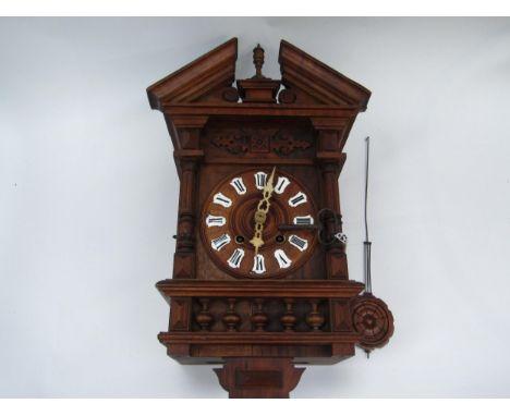 A late 19th early 20th Century German Cuckoo clock with spring driven movement in unusual wooden case, striking on coiled gon