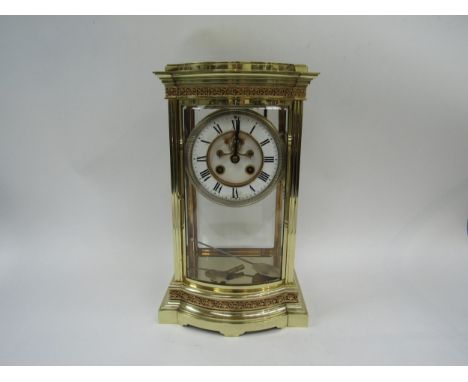 A Mid to late 19th Century French (AD Mougin) brass four glass mantel clock with bowed glass front door, all panels bevelled.