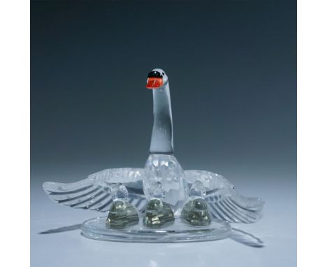 This Swarovski Silver Crystal Swan with Cygnets figurine beautifully captures the elegance of a mother swan with her three yo