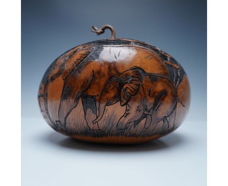 A striking hand-carved and etched gourd by artist F.G. Link, featuring a detailed depiction of elephants in their natural hab