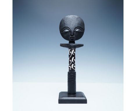 A handcrafted wooden Akuaba fertility figure from Kenya, featuring a stylized round head with carved facial features and an e