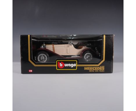 A Bburago 1:18 scale die-cast model of the 1928 Mercedes-Benz SSK. This finely detailed collectible features a beige and maro