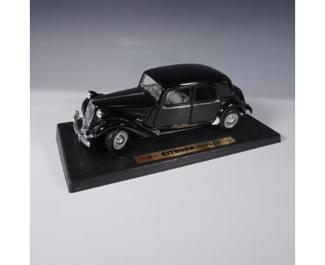 A highly detailed Tchibo 1:18 scale diecast model of the Citroen 15CV from 1952, mounted on a display base. This vintage-styl