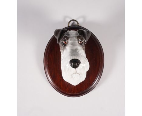 Features a beautifully sculpted dog head in vivid detail, mounted on an oval wooden base. The dog's face exhibits lifelike ey