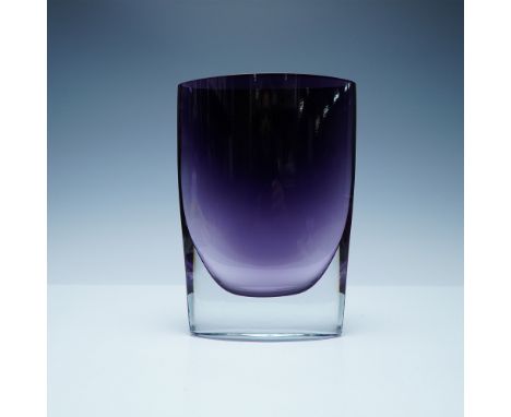A striking modern art glass vase featuring a sleek, asymmetric form with a smooth amethyst gradient that transitions into cle