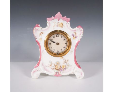 An elegant porcelain mantel clock featuring a Rococo Revival-style case with hand-painted floral motifs, pink-accented scroll