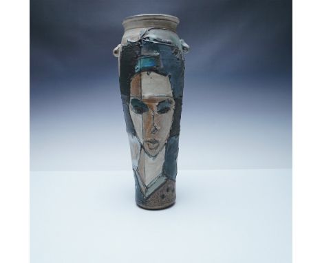 A unique handcrafted studio pottery vase marked Studio A, featuring a bold abstract portrait design. This tall, sculptural pi