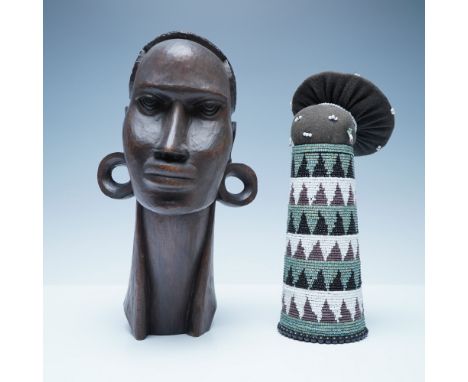 A striking pair of handcrafted African cultural artifacts. The first piece is a finely carved wooden bust (11") depicting a t