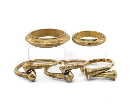 FIVE INDIAN BRASS BRACELETS, including pair of Naga bracelets from Manipur, another similar, a Nepali bangle inscribed 'Tirth