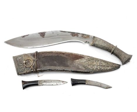 CEREMONIAL KUKRI, Nepal, 28cm poilished steel blade, floral embossed white metal hilt and pommel, with embossed white metal r