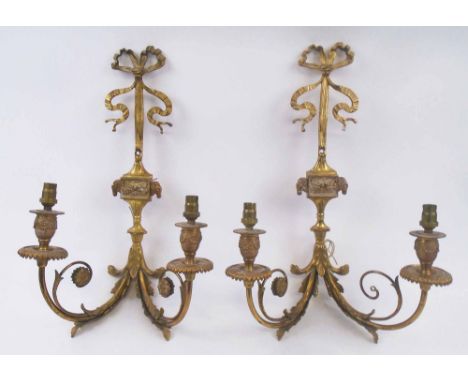 WALL APPLIQUES, a pair, gilt brass, each with twin lighting arms, foliate and ribbon cast detail, 46cm H x 27cm overall. (2)