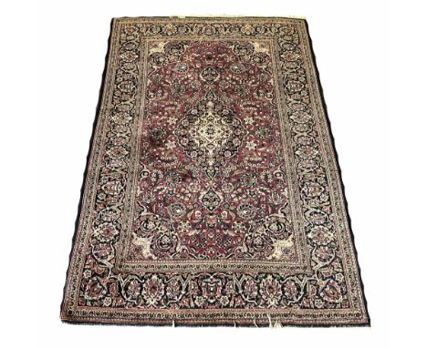 ANTIQUE KASHAN RUG, 207cm x 136cm, central medallion on a ruby palmette and scrolling vine field within complimentary bands a