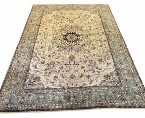 EXTREMELY FINE PART SILK TABRIZ CARPET, 340cm x 248cm, central medallion, on a palmette and vine field, within complimentary 