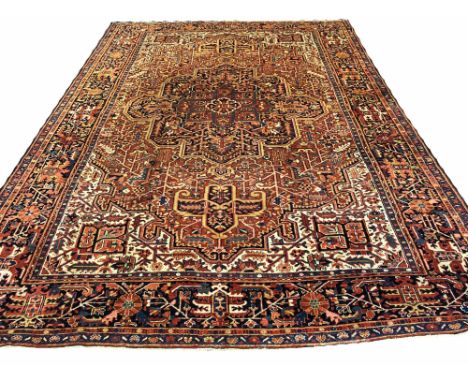 FINE ANTIQUE HERIZ CARPET, 378cm x 278cm, serapi design, central medallion on a terracotta stylised floral field, within comp