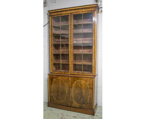 BOOKCASE, George III mahogany and inlaid birds-eye maple with a pair of glazed doors above enclosing shelves and two panelled