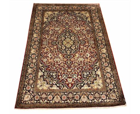 VERY FINE PURE SILK TEHRAN DESIGN RUG, 190cm x 128cm, central medallions on a ruby palmette and vine field, within compliment