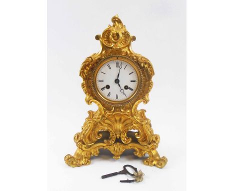 LOUIS XV MANTEL CLOCK, the florid cast gilt metal case, with white enamel dial, French bell striking movement, 33cm H. (pendu