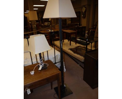 A modern wrought iron standard lamp by Jim Lawrence, complete with square tapering cream coloured shade.