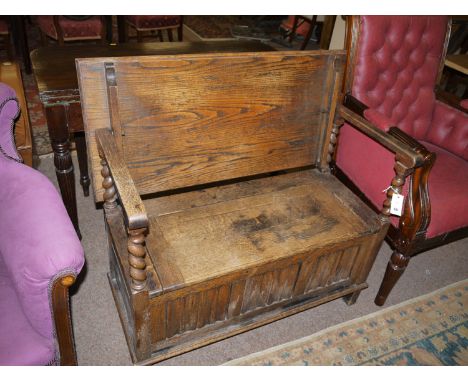 A early 20th Century reproduction oak monk's bench.