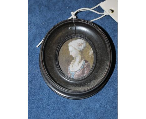 An early 20th Century miniature portrait on ivory, of a lady in 18th Century costume, in stained wood oval frame.