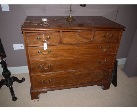 A Georgian mahogany chest of drawers with moulded edge, above three short and three long graduating drawers with brass swan n
