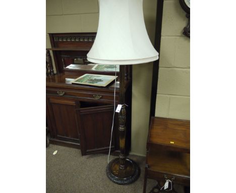 A mid 20th Century carved, reeded and turned oak standard lamp, with cream coloured shade.