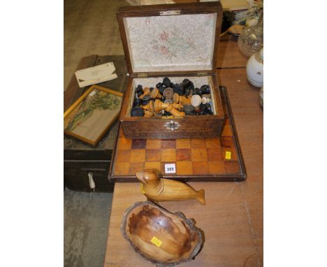 A wood chess set and board; a Victorian inlaid box; a model of a seal; and a wooden bowl.