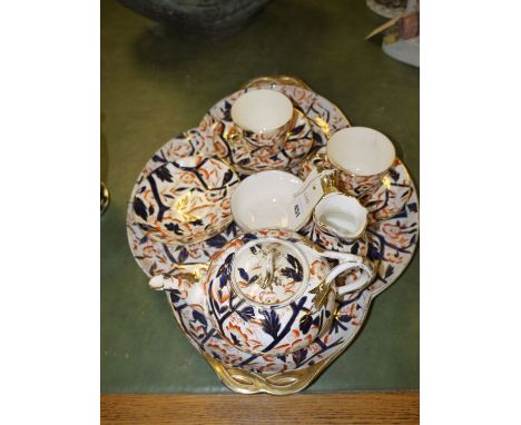 A 19th Century nine-piece tea-for-two tea set, comprising: teapot, sugar and cream, two cups and saucers, a spare saucer, and