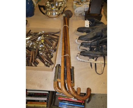 An early 20th Century shooting stick with folding canework seat; a swagger stick; and two walking sticks.