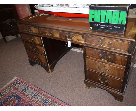 A reproduction mahogany Georgian style pedestal desk, with inset imitation tooled leather writing surface and moulded edge, f