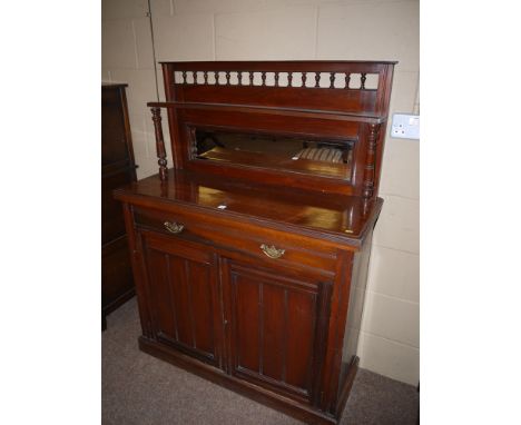 A small Victorian walnut chiffonier with mirror panel back, the shelf supported by a turned column, fitted a shallow drawer t