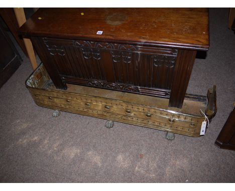 A 19th Century brass firecurb with pierced decoration and paw feet; together with a Royal portable typewriter.