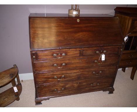A Georgian mahogany bureau, the fall-flap with crossbanded and inlaid stringing, opening to reveal a fitted interior with cen