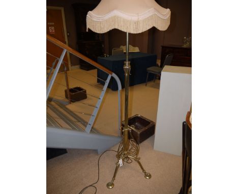 A 19th Century brass lamp standard with height adjustable mechanism, converted to electricity, and fitted a modern dark cream