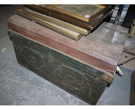 An old tin trunk with folding carrying handles.