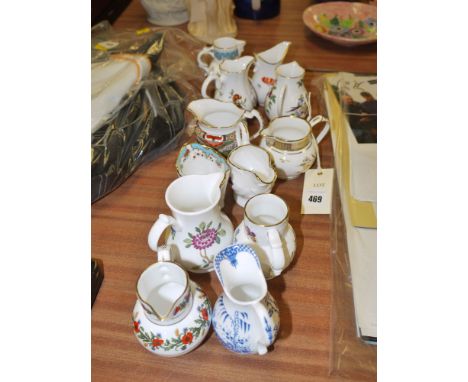 A collection of twelve small reproduction Royal Worcester jugs, various.