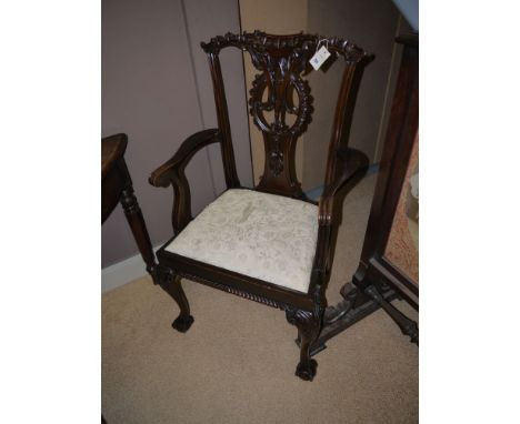 A Chippendale style carver dining chair with ornate carved cresting rail and pierced and carved vase-shaped splat, fitted sha