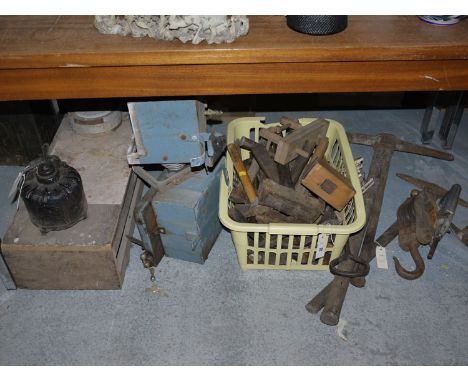 A collection of hand tools, mainly hammers; pulley block; electric motors; etc.