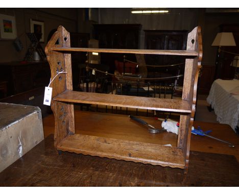 A 19th Century oak three-tier wall hanging shelf unit with pierced decoration on the shaped sides.