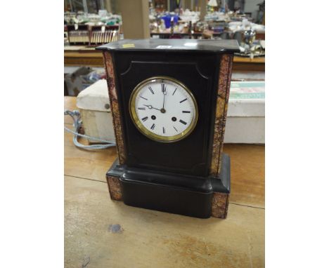 A large Victorian mantel clock in polished slate and decorative marble case, the circular white enamel dial with roman numera