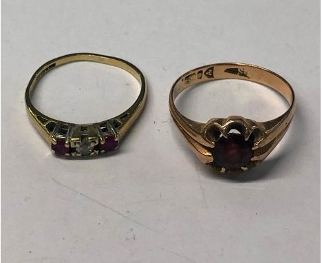 A 9ct yellow gold three stone ring, the central circular diamond flanked by a circular ruby on each side, size I to/w a 9ct r