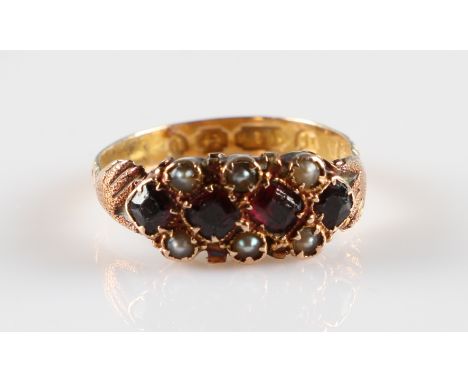 A Victorian 15ct rose gold ruby and seed pearl ring, set with four cushion cut rubies with six seed pearls, with hand motif s