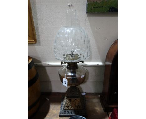 A Square Metallic Based Oil Lamp With Glass Reservoir And Shade