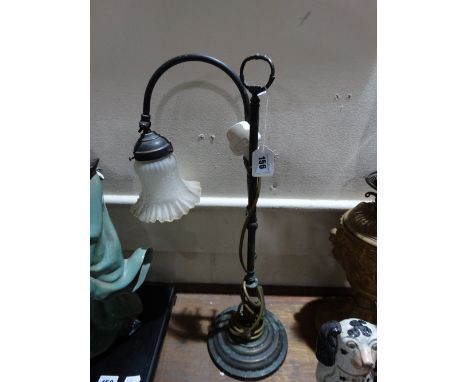 A Circular Based Adjustable Reading Lamp With Glass Shade