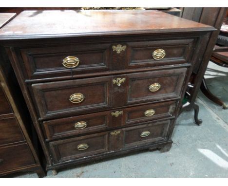 An Antique Oak Panelled Four Drawer Chest On Bracket Feet
