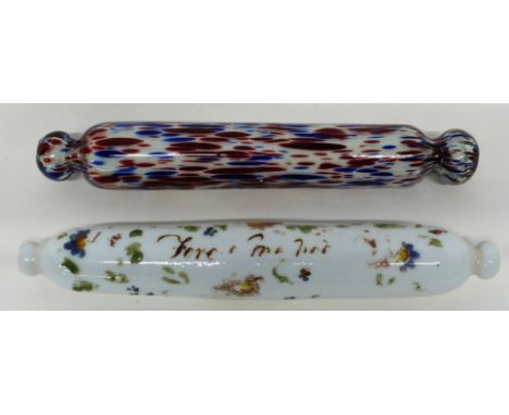 Two glass rolling pins, one with floral design with indistinct inscription, further pin with a streaked red and blue design (