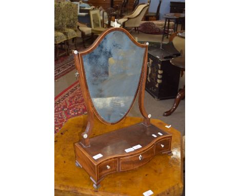 Edwardian shield-shaped toilet mirror raised on a serpentine three drawer base with ivory escutcheons and highlights with str